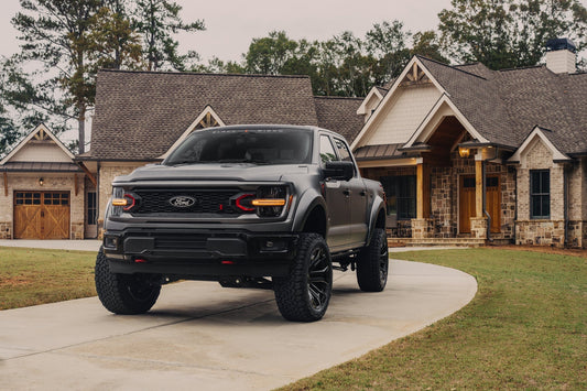 Black Widow F-150 with an aggressive stance at a beautiful home